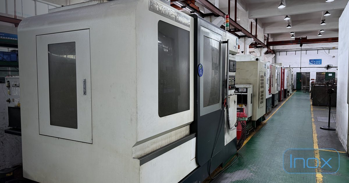 A row of CNC machining centres on the Dongguan factory floor