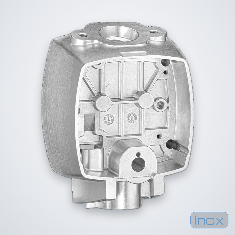 An aluminium die-cast housing showing as-cast ribs, bosses and a machined bore face
