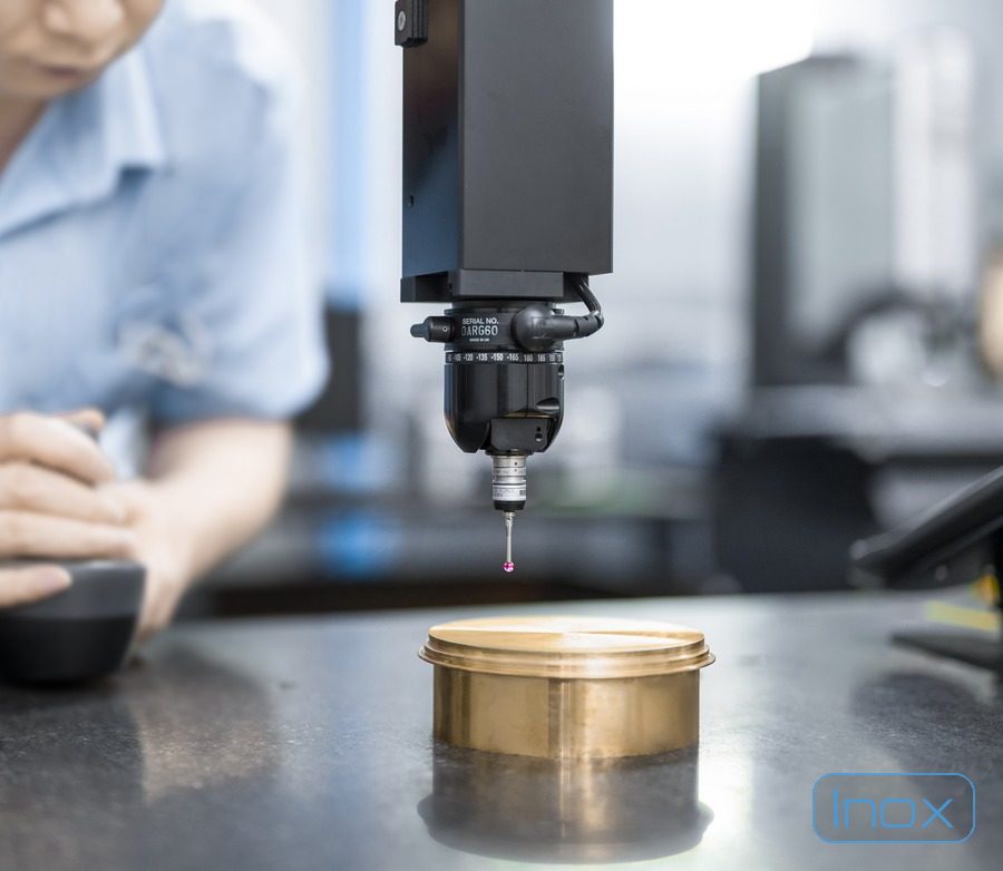 A coordinate measuring machine touch probe measuring a part on the granite table